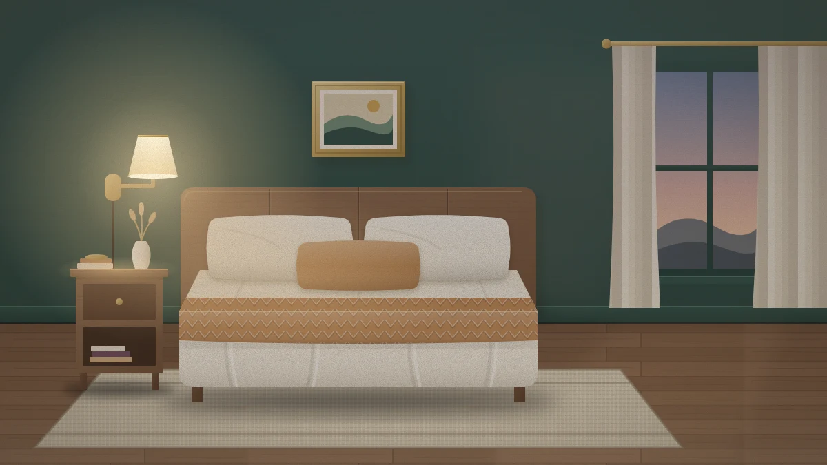A small moody bedroom with deep forest green walls and matching trim, ivory linen bedding, a caramel throw and a glowing brass wall lamp